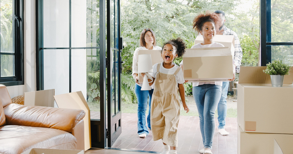 A family moving into their new home with moving boxes